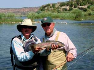 Capt. Mark Nesbit and client showing off a nice San Juan rainbow trout.