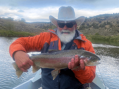 Capt. Mark and his client both look very satisfied over this big rainbow trout on the San Juan.