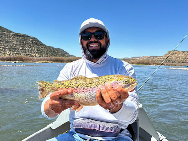 San Juan angler with big fat rainbow trout.