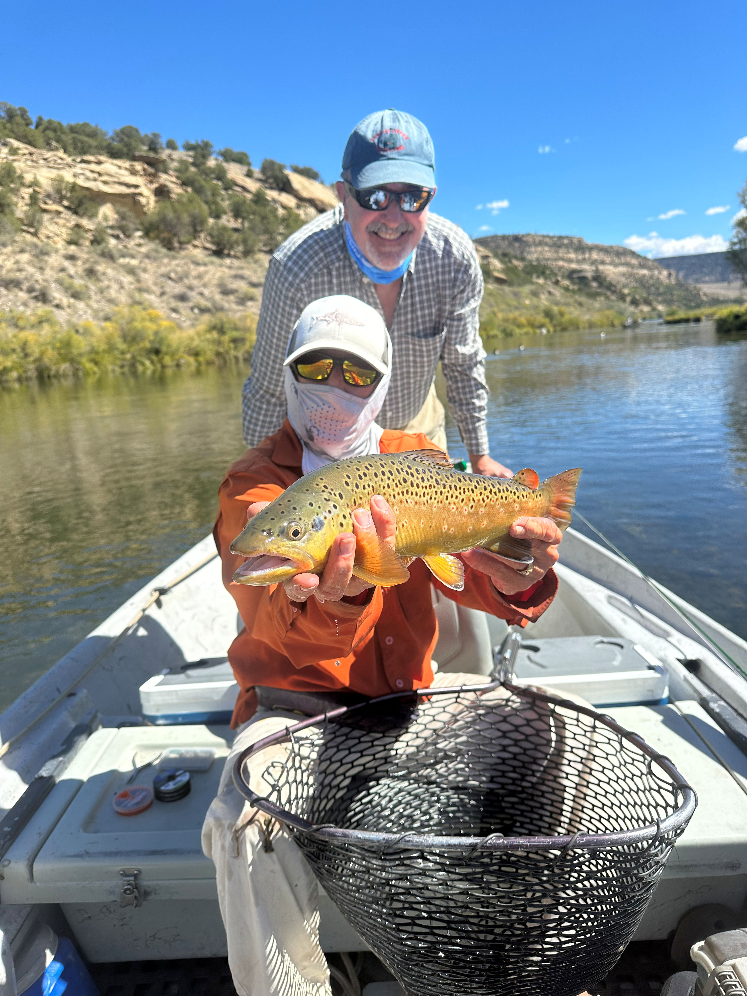 Client releasing large rainbow trout.