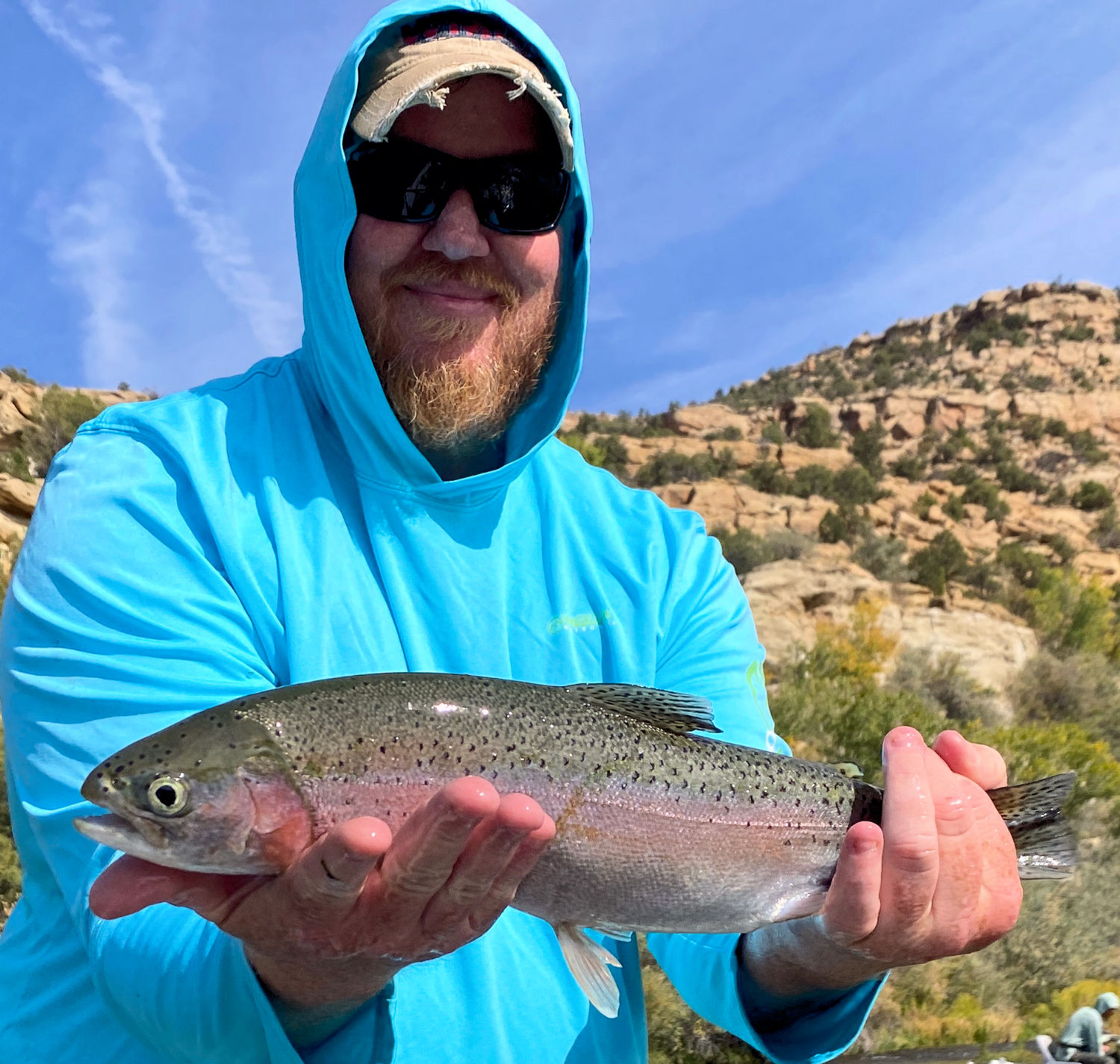Client releasing large rainbow trout.